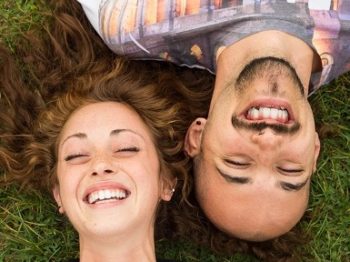 Couple of guys laughing and joking at the park