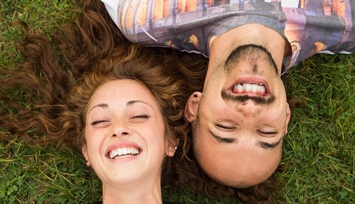 Couple of guys laughing and joking at the park